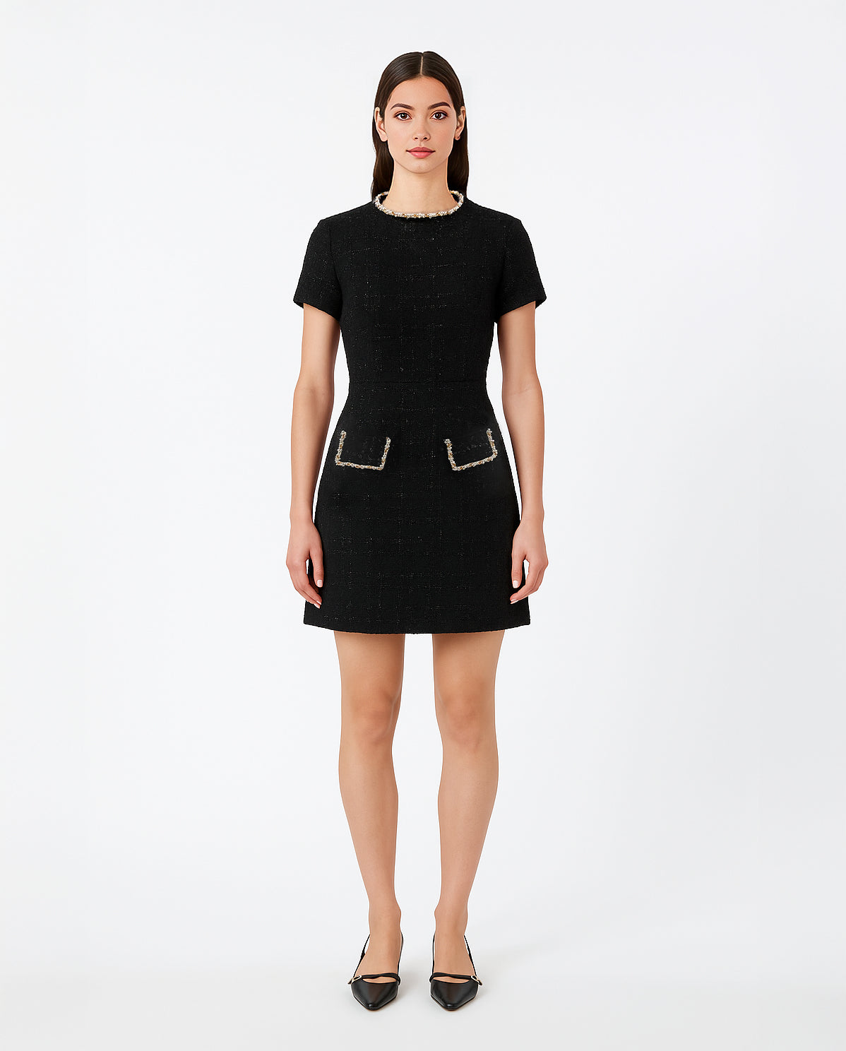 Front view of model wearing the Saint Rae Camille black tweed mini dress, a sophisticated Chanel-inspired short sleeve A-line dress with pearl-trim neckline and pocket accents, ideal for workwear, cocktail hours, or elegant day events.